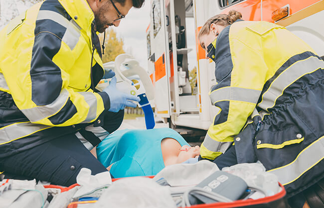 two paramedics placing a collar on an injured woman