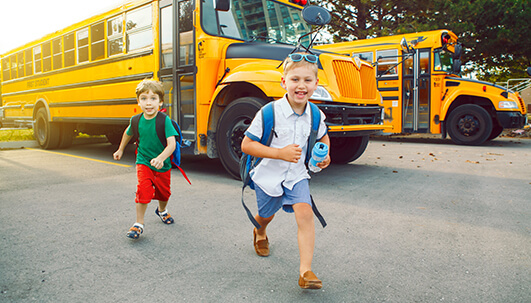 Children running out of a school bus