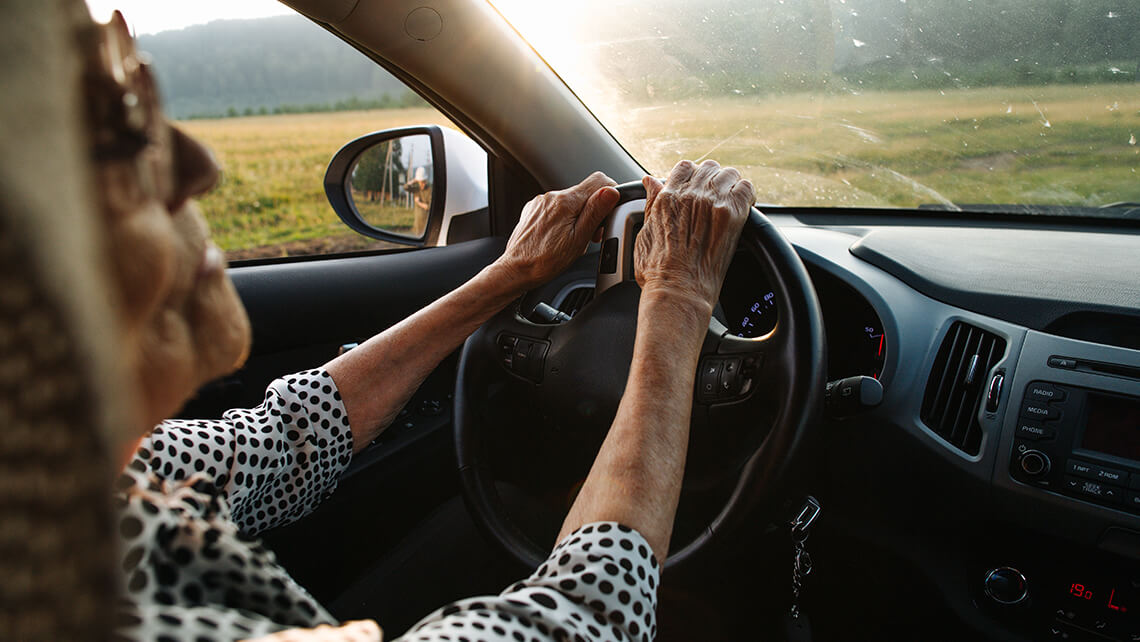 older woman driving a car
