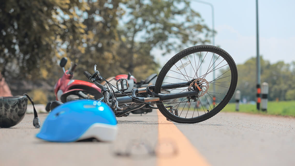 helmet and bike on ground after a crash